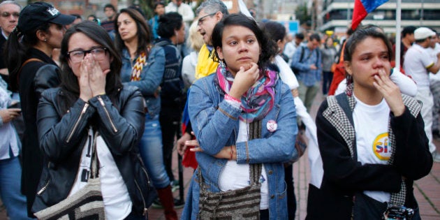 Supporters of the peace accord signed between the Colombian government and rebels of the Revolutionary Armed Forces of Colombia, FARC, follow on a giant screen the results of a referendum to decide whether or not to support the deal in Bogota, Colombia, Sunday, Oct. 2, 2016. Colombia's peace deal with leftist rebels was on the verge of collapsing in a national referendum Sunday, with those opposing the deal leading by a razor-thin margin with almost all votes counted.(AP Photo/Ariana Cubillos)