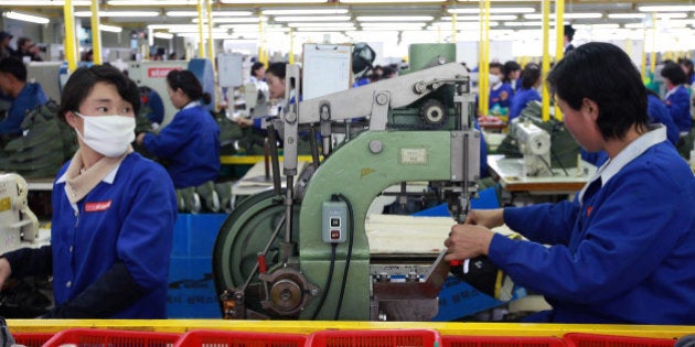 KAESONG, NORTH KOREA - DECEMBER 19: North Korean employees work at the assembly line of the factory of South Korean company at the Kaesong industrial complex on December 19, 2013 in Kaesong, North Korea. North Korea agreed on this rare cross-border trip of about 30 foreign officials and financial experts proposed by South Korea as the South Korean government watches on Pyongyang following the execution of leader Kim Jong-Un's uncle, Jang Song-Thaek. The Kaesong Industrial Complex was re-opened in September after a five-month closure caused by military tensions. (Photo by Park Jin-Hee-Pool/Getty Images)