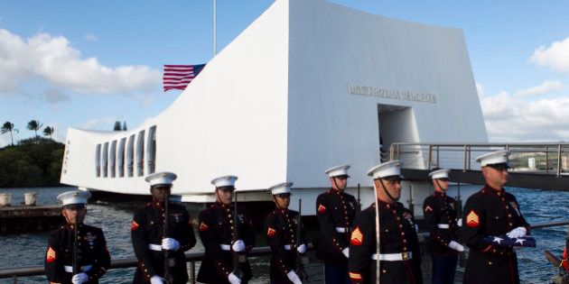 U.S. Marines stand at attention as the family of Pfc. Frank R. Cabiness arrives at a ceremony to have his ashes interred inside the USS Arizona, Friday, Dec. 23, 2011 in Honolulu. Cabiness, who was aboard the USS Arizona when the Japanese attacked, narrowly avoided getting hit by machine gun fire, and luckily his only injury was from friction burns suffered when he slid down a ladder while rushing to abandon ship. Cabiness, who died in 2002, is the second Marine to be interred within the USS Arizona. (AP Photo/Marco Garcia)
