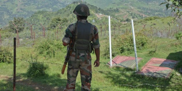 An Indian army soldier guards near fencing on the line of control near Balakot sector in Poonch, Jammu and Kashmir, India, Monday, Aug.17, 2015. Despite a 2003 cease-fire, the two neighbors regularly trade fire, the latest coming as India celebrated Independence Day on Saturday. Pakistan observed it a day earlier. (AP Photo/Channi Anand)