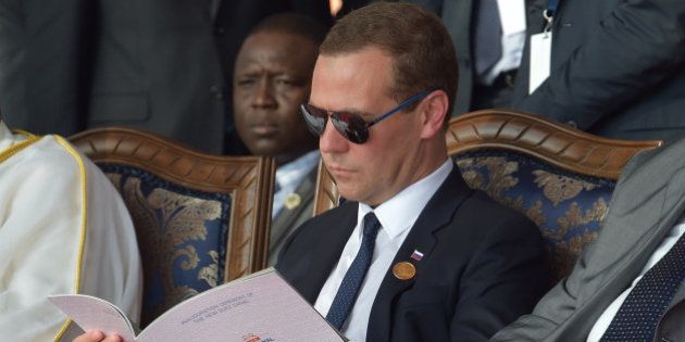 Russian Prime Minister Dmitry Medvedev, reads a program during the opening ceremony of the new section of the Suez Canal in Ismailia, Egypt, Thursday, Aug. 6, 2015. With much pomp and fanfare, Egypt on Thursday unveiled a major extension of the Suez Canal whose patron, President Abdel-Fattah el-Sissi, has billed as an historic achievement needed to boost the countryâs ailing economy after years of unrest. (Alexander Astafyev/RIA Novosti, Government Press Service Pool Photo via AP)