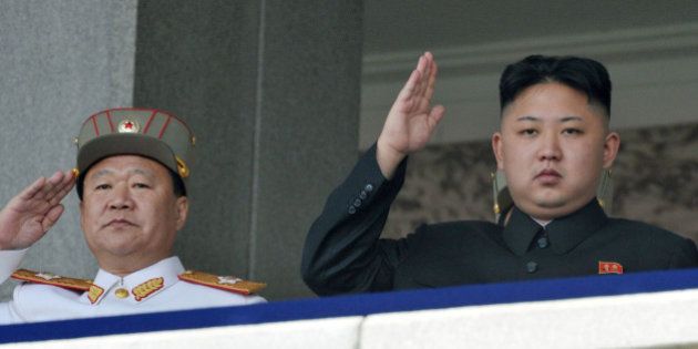 In this photo taken on April 15, 2012, North Korean leader Kim Jong Un, right, and Vice Marshal Choe Ryong Hae salute during a mass military parade in Kim Il Sung Square to celebrate the centenary of the birth of his grandfather, national founder Kim Il Sung in Pyongyang, North Korea. (AP Photo/Kyodo News) JAPAN OUT, MANDATORY CREDIT
