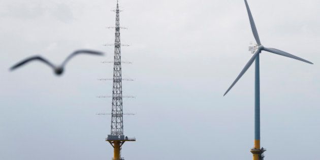 A 2.4-megawatt wind turbine developed by New Energy and Industrial Technology Development Organization (NEDO) in a joint research project with Tokyo Electric Power Co. (Tepco), right, and an observation tower stand in the sea off the coast of Choshi City, Chiba Prefecture, Japan, on Monday, March 4, 2013. Japan will begin operating two offshore wind turbines this year as it tries to diversify its energy mix and develop turbine technologies. Photographer: Kiyoshi Ota/Bloomberg via Getty Images