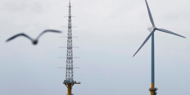 A 2.4-megawatt wind turbine developed by New Energy and Industrial Technology Development Organization (NEDO) in a joint research project with Tokyo Electric Power Co. (Tepco), right, and an observation tower stand in the sea off the coast of Choshi City, Chiba Prefecture, Japan, on Monday, March 4, 2013. Japan will begin operating two offshore wind turbines this year as it tries to diversify its energy mix and develop turbine technologies. Photographer: Kiyoshi Ota/Bloomberg via Getty Images