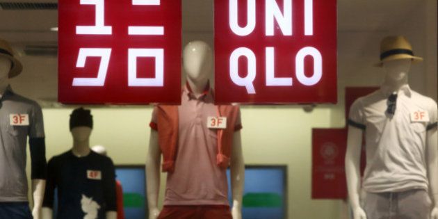 Signage for Uniqlo is displayed in a window of a store, operated by Fast Retailing Co., in Tokyo, Japan, on Wednesday, April 8, 2015. Fast Retailing, Asia's largest clothing retailer, is scheduled to announce earnings on April 9. Photographer: Tomohiro Ohsumi/Bloomberg via Getty Images