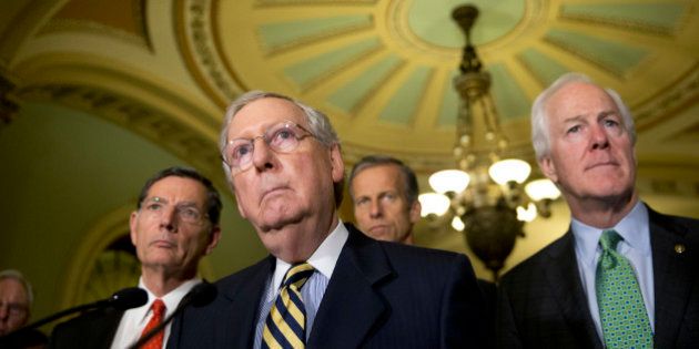 FILE - In tis June 21, 2016, file photo, Senate Majority Leader Mitch McConnell of Ky., accompanied by, from left, Sen. John Barrasso, R-Wyo., Sen. John Thune, R-S.D., and Senate Majority Whip John Cornyn of Texas, listen to a question during a news conference on Capitol Hill in Washington. Democrats opened a last-minute push Tuesday, Sept. 27, for new talks on must-do legislation to prevent the government from shutting down this weekend, fight the Zika virus and help flood-ravaged Louisiana rebuild. The aim is to see if Republicans will relent and add money to help Flint, Mich., with its water crisis â and get Capitol Hill off a collision course that could lead to a government shutdown this weekend. (AP Photo/Alex Brandon, File)