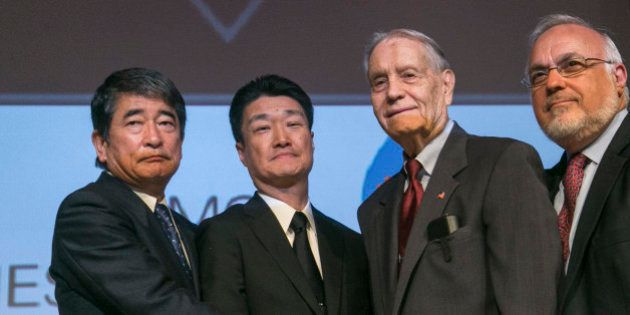 Yukio Okamoto, Outside Board Member of Mitsubishi Materials and former Special Advisor to Japan's Prime Minister, left, and Hikaru Kimura, Senior Executive Officer Mitsubishi Materials, offer an apology as they hold hands with 94-year-old U.S. prisoner of war, James Murphy, at the Simon Wiesenthal Center in Los Angeles, Sunday, July 19, 2015. Some 12,000 American prisoners were shipped to Japan and forced to work at more than 50 sites to support imperial Japan's war effort, and about 10 percent died, according to Kinue Tokudome, director of the U.S.-Japan Dialogue on POWs, who has spearheaded the lobbying effort for companies to apologize. (AP Photo/Damian Dovarganes)