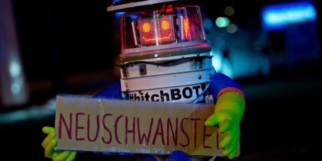 Robot 'hitchBOT' is seen holding a sign reading 'Neuschwanstein' as he waits for a lift at the roadside in Munich, southern Germany, on February 13, 2015. HitchBOT, a charming robot assembled using household parts who was hitchhiking more than 6,000 kilometers across Canada in summer 2014 as part of a social experiment, started his tour across Germany, where he is aimed to visit among others Neuschwanstein Castle in the South, the carnival in Cologne (West), the North Sea island of Sylt, the eastern city of Goerlitz near the Polish border and the German capital Berlin. AFP PHOTO / DPA / SVEN HOPPE +++ GERMANY OUT (Photo credit should read SVEN HOPPE/AFP/Getty Images)