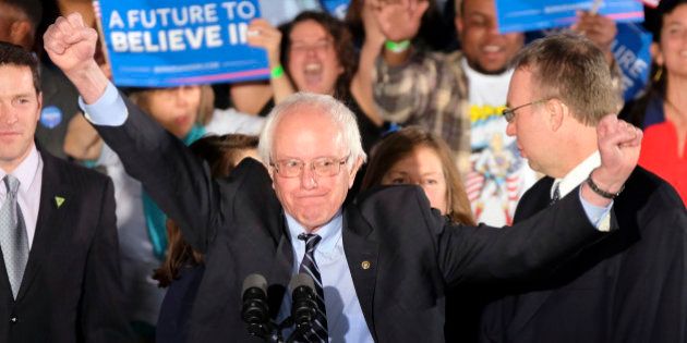 Democratic presidential candidate, Sen. Bernie Sanders, I-Vt., reacts to the cheering crowd at his primary night rally Tuesday, Feb. 9, 2016, in Manchester, N.H. (AP Photo/J. David Ake)