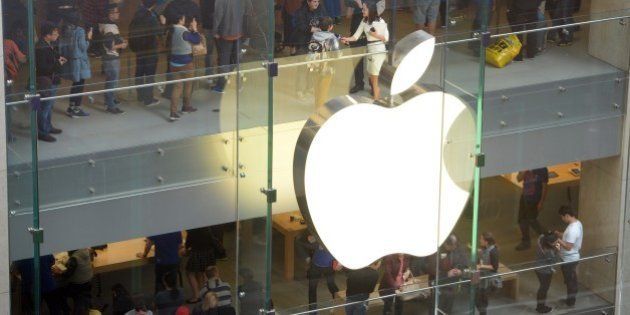 Customers queue in an Apple store to buy the iPhone 6 in Sydney on September 19, 2014. Hundreds of people queued through the night in Sydney to be among the first in the world to get their hands on the new Apple iPhone 6 models with the large-screen handsets drawing keen interest. AFP PHOTO / Saeed KHAN (Photo credit should read SAEED KHAN/AFP/Getty Images)