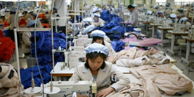 FILE - In this Dec. 19, 2013, file photo, North Korean workers assemble jackets at a factory of a South Korean-owned company at the jointly-run Kaesong Industrial Complex, in Kaesong, North Korea. South Korea says Wednesday, Feb. 10, 2016 it will halt operations at joint industrial park with North Korea in response to the North's recent rocket launch. (Kim Hong-Ji/Pool Photo via AP, File)