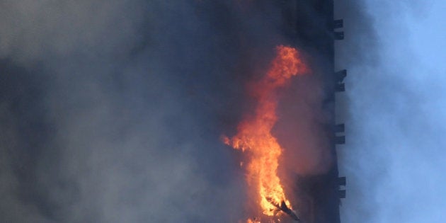 Fames and smoke billow as firefighters deal with a serious fire in a tower block at Latimer Road in West London, Britain June 14, 2017. REUTERS/Toby Melville