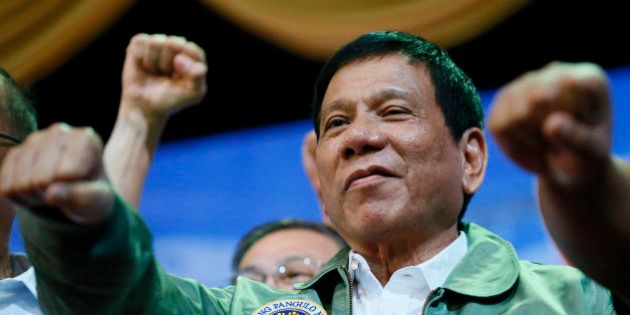 CHANGES AIRLIFT SQUAD NUMBER Philippine President Rodrigo Duterte poses with a fist bump during his