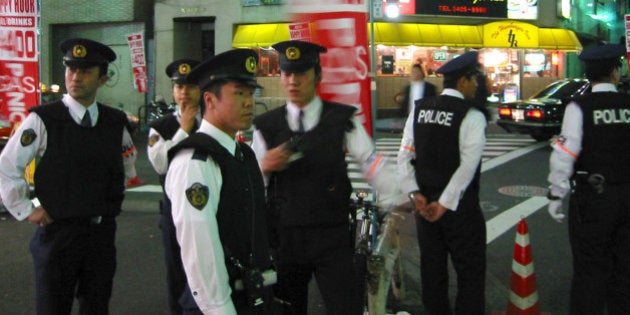 Japanese police patrol a street in down town Tokyo May 31, 2002 priorto the England - Sweden match in Saitama city. Britain banned more than1,000 suspected soccer hooligans from travelling to the World Cup inSouth Korea and Japan, requiring them to turn over their passports orface a six-month jail term. REUTERS/Pawel KopczynskiPK/WS