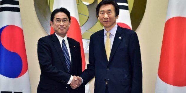 South Korean Foreign Minister Yun Byung-se, right, shakes hands with his Japanese counterpart Fumio Kishida, left, during their meeting at the foreign ministry in Seoul Saturday, March 21, 2015. The foreign ministers of South Korea, China and Japan will meet for the first time in three years this weekend after bitter disputes over history and territory drastically scaled back high-level contacts and even raised security fears. (AP Photo/Jung Yeon-je, Pool)
