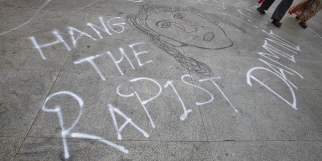 Commuters walk on a pathway that was painted by protesters outside the hospital where a five-year-old girl, who was raped and tortured, is admitted in New Delhi April 23, 2013. The police arrested a second man on Monday in connection with the rape and torture of the five-year-old girl in New Delhi and parliament was adjourned twice amid an uproar about the crime which has rekindled popular fury at widespread sexual violence.REUTERS/Mansi Thapliyal (INDIA - Tags: CIVIL UNREST SOCIETY CRIME LAW)