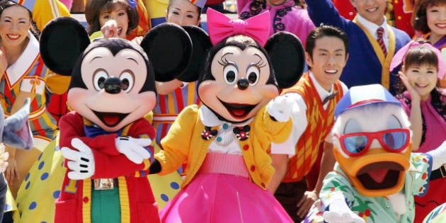 Mickey, Minnie Mouse and Donald Duck dance on 60s rock and roll music for the new attraction 'Disney Rock Around the Mouse' at the Tokyo Disneyland during a preview, 14 April 2005. Disney's theme land will start the new dance event from 15 April on the park's 22nd anniversary day. AFP PHOTO/Yoshikazu TSUNO (Photo credit should read YOSHIKAZU TSUNO/AFP/Getty Images)