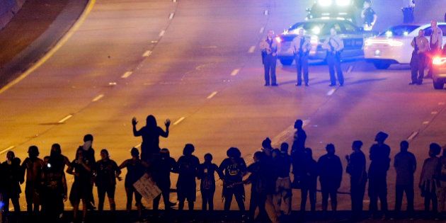 FILE - In this Thursday, Sept. 22, 2016 file photo, protesters block I-277 during a third night of unrest following Tuesday's police fatal shooting of Keith Lamont Scott in Charlotte, N.C. Protesters who have filled the streets to push for the release of video of Scott's shooting could see their task get much harder if Charlotte authorities do not share the footage within a week. A North Carolina law that takes effect Oct. 1 will declare that the video is not a public record and that only a judge can release it. (AP Photo/Gerry Broome, File)