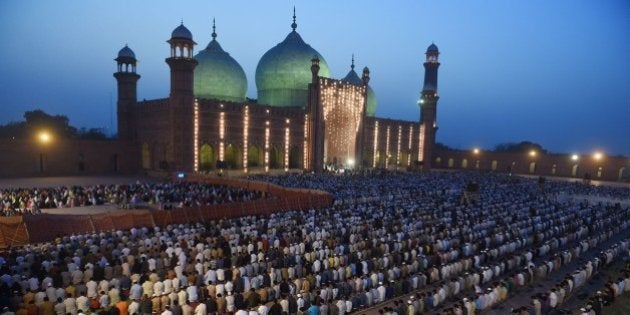 Pakistani worshippers offer evening prayers at the historical Badshahi mosque in Lahore on April 25, 2015, led by the Saudi Arabian Imam of the Grand Mosque in Mecca Sheikh Khalid al Ghamdi. Sheikh Khalid al Ghamdi arrived in Pakistan to meet with senior leaders of the ruling Pakistan Muslim League-Nawaz (PML-N). AFP PHOTO / Arif ALI (Photo credit should read Arif Ali/AFP/Getty Images)