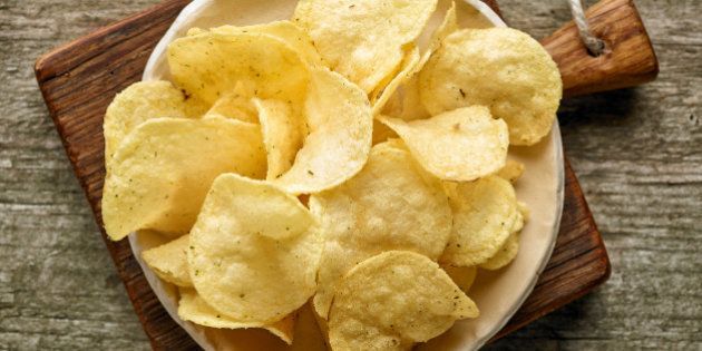 potato chips on wooden table, top view
