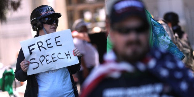 BERKELEY, CA - APRIL 27: A right wing activist holds a sign during a rally at Martin Luther King Jr. Civic Center Park on April 27, 2017 in Berkeley, California. Protestors are gathering in Berkeley to protest the cancellation of a speech by American conservative political commentator Ann Coulter at UC Berkeley. (Photo by Justin Sullivan/Getty Images)