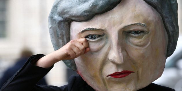 Protestor wearing a Theresa May mask poses outside Downing Street after Britain's election in London, Britain June 9, 2017. REUTERS/Neil Hall