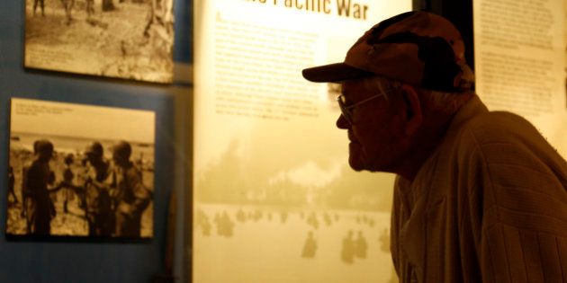 World War II veteran Arthur Robinson of Saratoga Springs, N.Y., looks at a display at the New York State Military Museum on Thursday, May 8, 2014, in Saratoga Springs. The Armyâs 27th Infantry Division, which Robinson served in, bore the brunt of Japanâs largest mass suicide attack, launched before dawn on July 7, 1944, on the island of Saipan. The divisionâs 105th Regiment saw more than 400 killed and 500 wounded during the attack by more than 3,000 Japanese soldiers and sailors. The 27th was a former New York National Guard unit that still had many New Yorkers among its ranks when it landed on Saipan after the U.S. Marines made the initial beach assault on June 15, 1944. (AP Photo/Mike Groll)