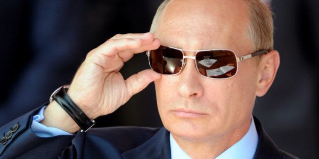 Russian Prime Minister Vladimir Putin adjusts his sunglasses as he watches an air show during MAKS-2011, the International Aviation and Space Show, in Zhukovsky, outside Moscow, on August 17, 2011. AFP PHOTO / DMITRY KOSTYUKOV / AFP / DMITRY KOSTYUKOV (Photo credit should read DMITRY KOSTYUKOV/AFP/Getty Images)