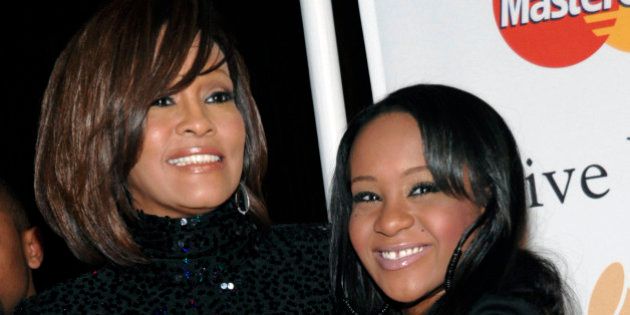 FILE - In this Feb. 12, 2011, file photo, singer Whitney Houston, left, and daughter Bobbi Kristina Brown arrive at an event in Beverly Hills, Calif. Brown, who was in hospice after months of receiving medical care, died on Sunday, July 26, 2015. (AP Photo/Dan Steinberg, File)