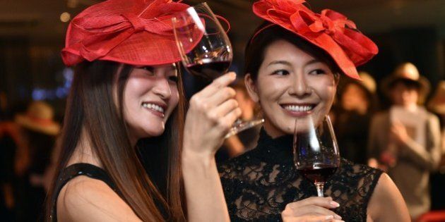 Japanese wine drinkers toast the 2014 vintage Beaujolais Nouveau wine at an event in Tokyo on November 20, 2014, after an embargo on the wine was removed at midnight. A total of seven million bottles of Beaujolais Nouveau wine are expected to be imported to Japan this year. AFP PHOTO/Yoshikazu TSUNO (Photo credit should read YOSHIKAZU TSUNO/AFP/Getty Images)