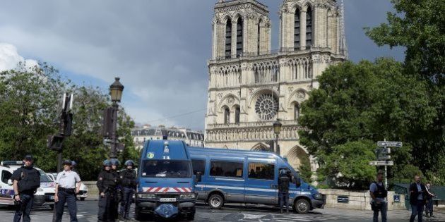 French police officials gather at the entrance to Notre-Dame cathedral in Paris on June 6, 2017. A French police officer has shot and injured a man who attacked him with a hammer outside Paris's Notre-Dame cathedral authorities said. Police sealed off the area in front of the cathedral, where the attacker lay injured on the ground. / AFP PHOTO / bertrand GUAY (Photo credit should read BERTRAND GUAY/AFP/Getty Images)