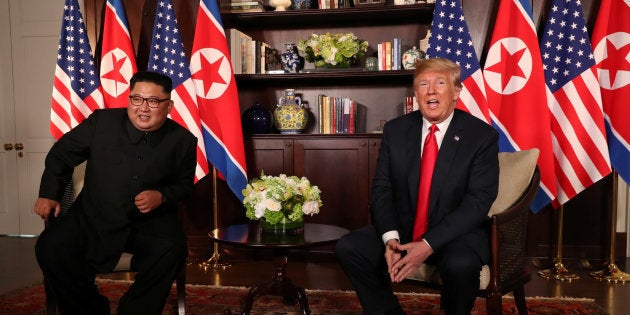 U.S. President Donald Trump sits next to North Korea's leader Kim Jong Un before their bilateral meeting at the Capella Hotel on Sentosa island in Singapore June 12, 2018. REUTERS/Jonathan Ernst