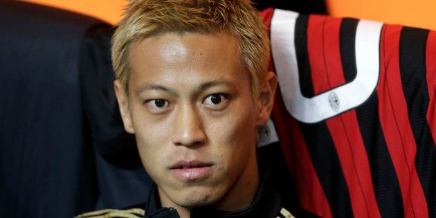 AC Milan's Keisuke Honda looks on as he sits on the bench before the Italian Serie A soccer match against Inter Milan at San Siro stadium in Milan May 4, 2014. REUTERS/Max Rossi (ITALY - Tags: SPORT SOCCER HEADSHOT)