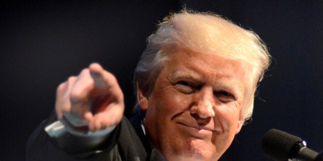 U.S. President Donald Trump points to a guest as he arrives onstage for concluding remarks as first lady Melania Trump looks on, at the Ford's Theatre Gala, an annual charity event to honor the legacy of President Abraham Lincoln, in Washington, U.S., June 4, 2017. REUTERS/Mike Theiler