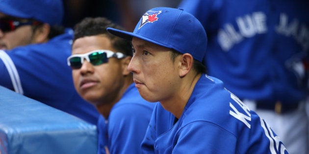 TORONTO, CANADA - JUNE 29: Munenori Kawasaki #66 of the Toronto Blue Jays looks on from the dugout next to Marcus Stroman #54 during MLB game action against the Chicago White Sox on June 29, 2014 at Rogers Centre in Toronto, Ontario, Canada. (Photo by Tom Szczerbowski/Getty Images)