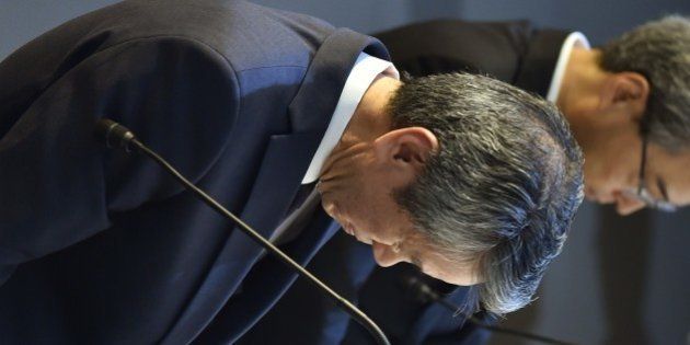 President of Toshiba, Hisao Tanaka (L) bows at the end of a press conference at the company's headquarters in Tokyo on July 21, 2015. Toshiba president Hisao Tanaka and his predecessor Norio Sasaki quit the company on July 21 as one of Japan's best-known firms was hammered by a 1.2 billion USD accounting scandal blamed on management's overzealous pursuit of profit. AFP PHOTO / KAZUHIRO NOGI (Photo credit should read KAZUHIRO NOGI/AFP/Getty Images)