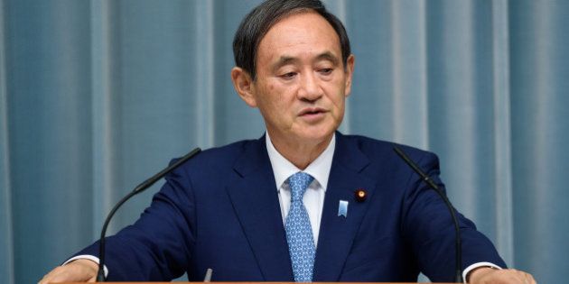 Yoshihide Suga, chief cabinet secretary of Japan, listens during a press conference at the official residence of Japan's Prime Minister Shinzo Abe, not pictured, in Tokyo, Japan, on Wednesday, Aug. 3, 2016. In a cabinet reshuffle that leaves most key personnel in place, Abe appointed a hawkish ally he once dubbed 'Joan of Arc' as defense minister amid tensions with his country's neighbors. Photographer: Akio Kon/Bloomberg via Getty Images