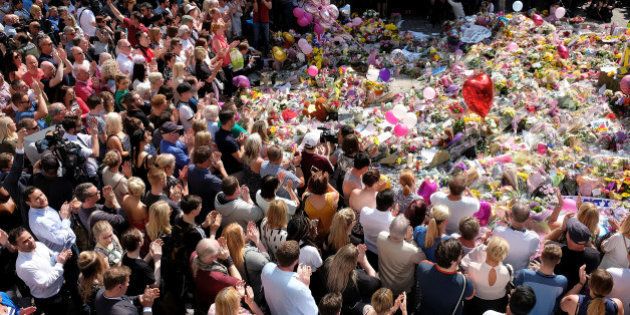 Members of the public attend a minute of silence for the victims of the Manchester Arena attack, in St Ann's Square, in central Manchester, Britain May 25, 2017. REUTERS/Darren Staples