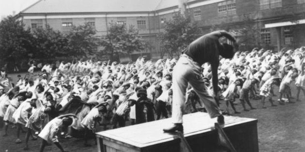 circa 1950: Radio Gymnastica conducts mass gymnastic drills throughout Tokyo primary schools during the Summer vacation. (Photo by Keystone/Getty Images)