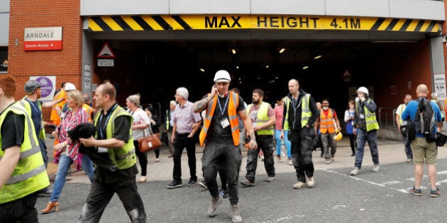 People rush out of the Arndale shopping centre as it is evacuated in Manchester, Britain May 23, 2017. REUTERS/Darren Staples