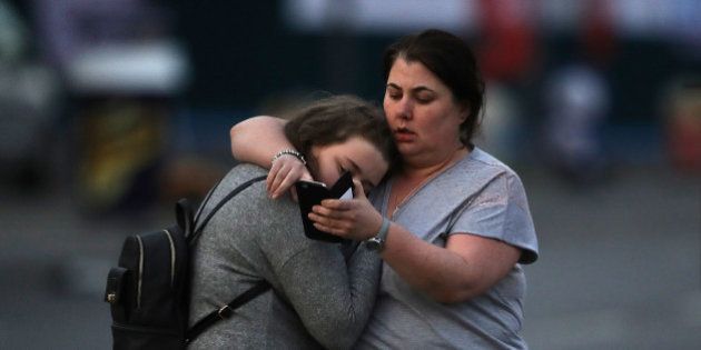 MANCHESTER, ENGLAND - MAY 23: Ariana Grande concert attendees Vikki Baker and her daughter Charlotte, aged 13, leave the Park Inn where they were given refuge after last night's explosion at Manchester Arena on May 23, 2017 in Manchester, England. An explosion occurred at Manchester Arena as concert goers were leaving the venue after Ariana Grande had performed. Greater Manchester Police have confirmed 19 fatalities and at least 50 injured. (Photo by Christopher Furlong/Getty Images)