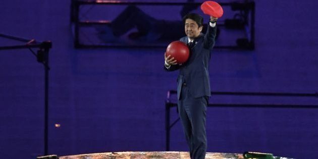 Japanese Prime Minister Shinzo Abe holds a red ball during the closing ceremony of the Rio 2016 Olympic Games at the Maracana stadium in Rio de Janeiro on August 21, 2016. / AFP / PHILIPPE LOPEZ (Photo credit should read PHILIPPE LOPEZ/AFP/Getty Images)