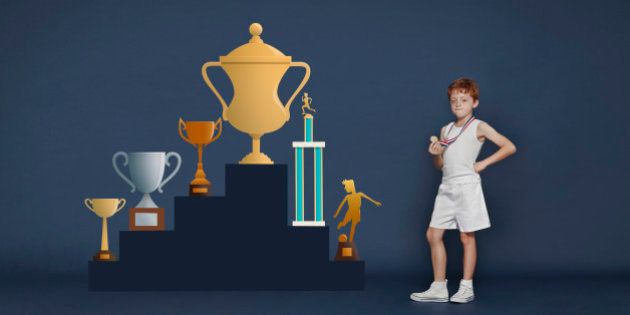 Boy with medal and trophies