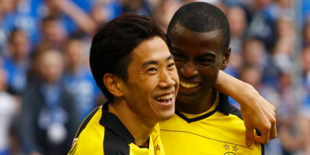 Football Soccer - FC Schalke 04 v BVB Dortmund - German Bundesliga - Veltins Arena , Gelsenkirchen, 10/04/16 Borussia Dortmund's Shinji Kagawa celebrates with Adrian Ramos after scoring a goal REUTERS/Wolfgang Rattay DFL RULES TO LIMIT THE ONLINE USAGE DURING MATCH TIME TO 15 PICTURES PER GAME. IMAGE SEQUENCES TO SIMULATE VIDEO IS NOT ALLOWED AT ANY TIME. FOR FURTHER QUERIES PLEASE CONTACT DFL DIRECTLY AT + 49 69 650050