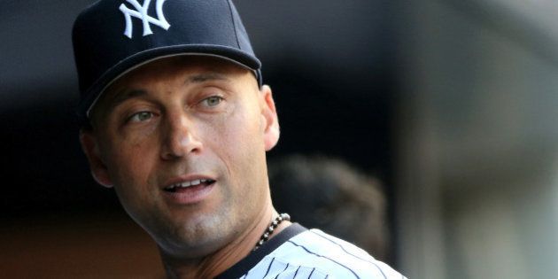 NEW YORK, NY - JULY 22: Derek Jeter #2 of the New York Yankees looks on from the dugout before the game against the Texas Rangers on July 22, 2014 at Yankee Stadium in the Bronx borough of New York City. (Photo by Elsa/Getty Images)