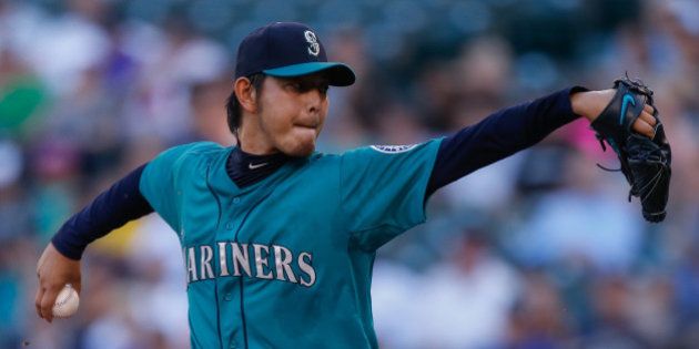 SEATTLE, WA - JULY 07: Starting pitcher Hisashi Iwakuma #18 of the Seattle Mariners pitches in the first inning against the Minnesota Twins at Safeco Field on July 7, 2014 in Seattle, Washington. (Photo by Otto Greule Jr/Getty Images)