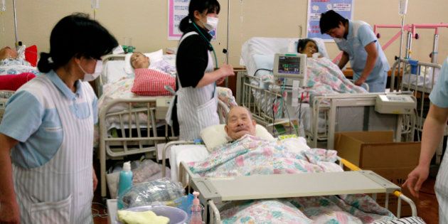Elderly patients, who were forced to move from a hospital near the Fukushima nuclear plant 60 kms to the north, receive care from nurses at a hospital in Koriyama in Fukushima prefecture on March 17, 2011. Japanese military helicopters dumped tonnes of water onto the stricken Fukushima nuclear power plant northeast of Tokyo in a bid to douse fuel rods and prevent a disastrous radiation release. AFP PHOTO / Go TAKAYAMA (Photo credit should read GO TAKAYAMA/AFP/Getty Images)