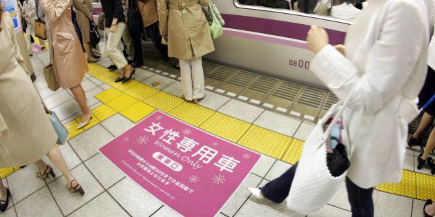 TOKYO, JAPAN - MAY 11: Female passengers come out from a 'Women Only' carriage at a metro station May 11, 2005 in Tokyo, Japan. Nine private railways and subway trains operated by the Tokyo metropolitan government began running 'Women Only' carriages during the morning hours in order to prevent railway gropers in crowded trains. (Photo by Junko Kimura/Getty Images)