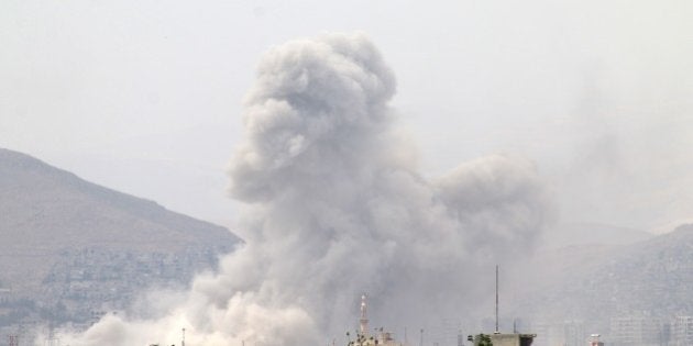 DAMASCUS, SYRIA - MAY 04: Smoke rises after Assad regime forces attacked opposition controlled Qaboun district of Damascus, Syria on May 04, 2017. Regime forces hit residential areas with ground and air strikes. (Photo by Samir Tatin/Anadolu Agency/Getty Images)