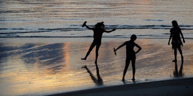 Two girls enjoy the waters of Agana Bay in Hagatna, Guam, on Aug. 10, 2015. The small island is expecting an influx of military as Marines shift training from Okinawa to Guam in a plan to reduce the number of troops on Okinawa, where locals have been vying for a reduced military presence for years. (Tiffany Tompkins-Condie/McClatchy DC/TNS via Getty Images)